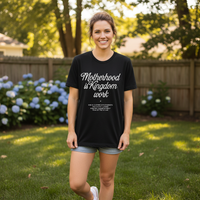 Woman wearing a black t-shirt with text in a garden